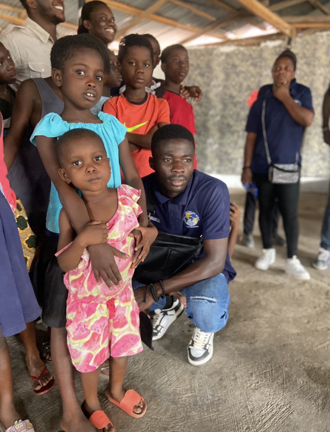 An IWF volunteer with children during an orphanage visit